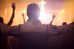 Worship concept: Christians raising  hands in praise and worship night